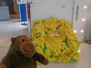Mr Monkey looking at a banana armchair