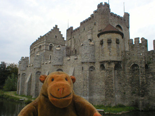 Mr Monkey walking past the Castle of the Counts