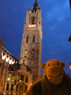 Mr Monkey looking up at the Belfort at dusk