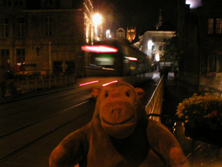 Mr Monkey watching a tram in the dark