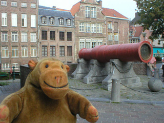 Mr Monkey looking at a very large medieval cannon
