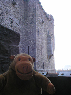 Mr Monkey looking at the outside of the keep from the walkway to the House of the Counts
