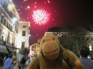 Mr Monkey watching red fireworks explode over Ghent