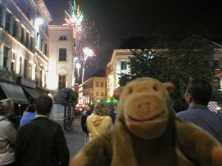 Mr Monkey watching white fireworks explode over Ghent