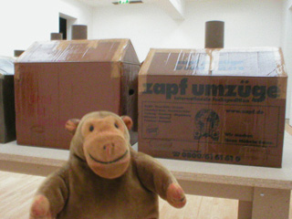 Mr Monkey looking at some box-like art in the museum