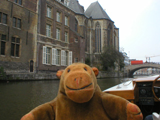 Mr Monkey approaching Sint-Michiels bridge and church