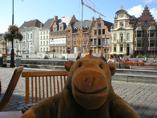 Mr Monkey looking at the Korenlei from a cafe on the Graslei