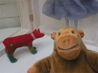 Mr Monkey looking at a red Dangerous Dog