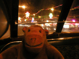Mr Monkey looking at Blackpool's lights from the front window of the tram
