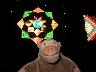 Mr Monkey in front of a geometric pattern of lights