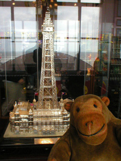 Mr Monkey looking at a silver model of the Tower