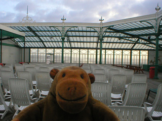 Mr Monkey looking at chairs in the sun lounge